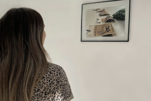 A participant looking at a picture on a wall during the photo exhibition "Youth through the lens of security" Bosnia and Herzegovina, October 2023 (Centar za psihološku podršku Sensus)
