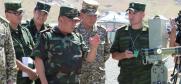 Chairman of the State Border Service (SBS) Colonel Abdikarim Alimbaev explains the work of the radio-communication equipment used by the SBS during the military Command-Staff Exercise ‘Barrier 2016’, Osh, 8 July 2016. (OSCE/ Ilona Asyrankulova)