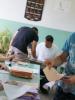A voter collects his ballot papers at a polling station in Staro Sajmište, Belgrade, during the parliamentary elections and early presidential elections in Serbia, 6 May 2012. (OSCE/Shiv Sharma)