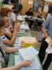 A voter collects his ballot papers at a polling station in Staro Sajmište, Belgrade, during the parliamentary elections and early presidential elections in Serbia, 6 May 2012. (OSCE/Shiv Sharma)